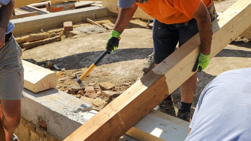 Roofing professional from Ruff Top Roofing inspecting structural integrity of a residential roof